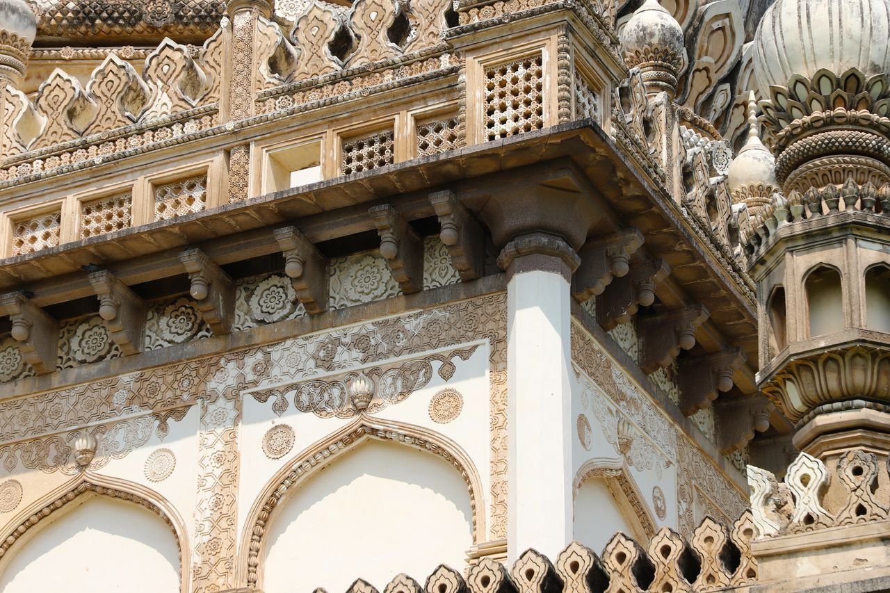Close-up of ornate architectural details on a historic building facade in Hyderabad, India.